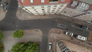 Aerial birds eye overhead top down tracking view of people riding bikes on cycle route in [upl. by Chem]