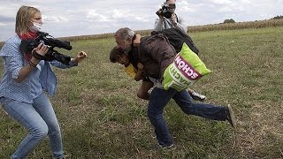 Hungarian camera woman caught on video kicking and tripping migrants [upl. by Novehs965]