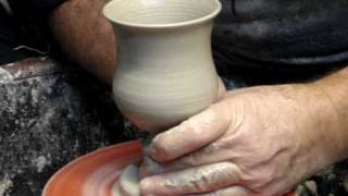 Throwing a clay pottery goblet single handed quickly on a potters wheel demonstration [upl. by Vada]