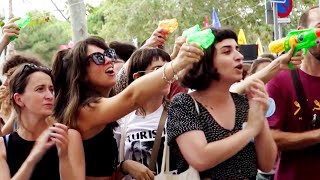 Protesters Spray American Tourists With Water Guns in Spain [upl. by Ianahs]