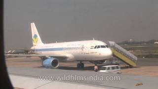 Air Deccan plane being boarded and Jet airways flight to Delhi taxiing at Kolkata Airport [upl. by Larina]