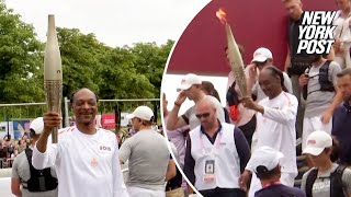 WATCH Snoop Dogg carries Olympic torch ahead of 2024 Opening Ceremony [upl. by Denny98]