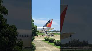 Philippine Airlines at Laoag airport Airport staffs offering parasols to passengers [upl. by Darej]