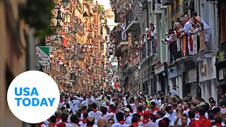 Thousands gather in Pamplona Spain for running of the bulls festival  USA TODAY [upl. by Elery]