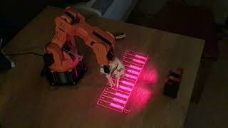 Robotic arm plays laser piano [upl. by Hare]