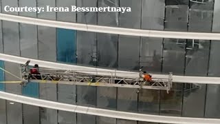 High winds cause workers to swing on scaffolding [upl. by Ecnerat]