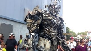 Megatron talks to guests outside Transformers The Ride attraction at Universal Orlando [upl. by Silvestro]