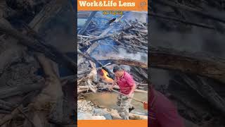 A man pours flammable liquid on flood debris under a bridge to clear the blockage for water flow [upl. by Ydasahc]