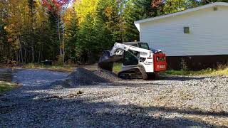 Spreading stone up the cabin with the Bobcat T450 [upl. by Aldos]