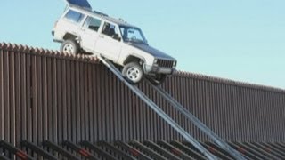 Mexican smugglers leave Jeep teetering on edge of California border fence [upl. by Quiteris249]