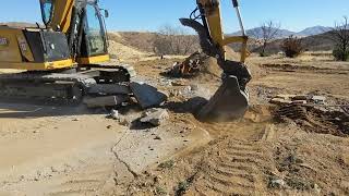 CAT 310 Excavator Breaking up a Concrete Pad [upl. by Ashwin447]