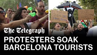 Antitourism protesters soak diners with water pistols in Barcelona [upl. by Retrop]