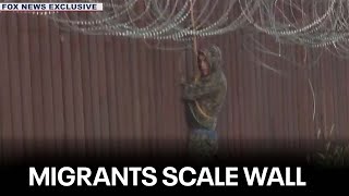 Caught on camera Migrants dressed in camo scale Arizona border wall [upl. by Atiniuq]