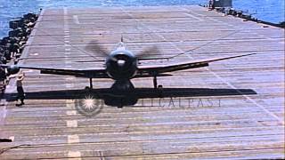 US F6F Hellcats landing on aircraft carrier in Pacific during WW II FirefighteHD Stock Footage [upl. by Labinnah]