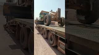 motor grader unloading trailer [upl. by Auqenwahs]