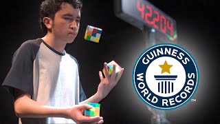 Solving Three Puzzle Cubes WHILST JUGGLING  Guinness World Records [upl. by Eldwun]