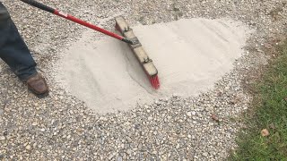 brushing CHEAP concrete onto a gravel driveway adding strength and resilience [upl. by Ruffin]