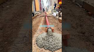 The process of pouring concrete from red metal pipe [upl. by Mcloughlin]