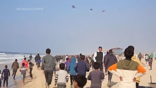 Hundreds gather in the beach southern Gaza Strip trying to get aid airdropped in the enclave [upl. by Malissa867]