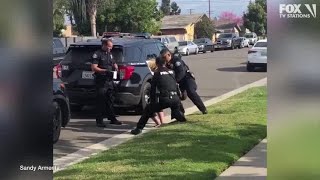 Police officers stop fellow officer punching handcuffed woman during arrest [upl. by Serilda217]