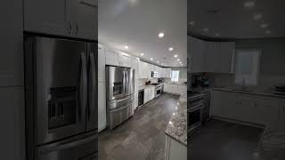 Galley Kitchen with White Shaker Cabinets Vinyl Floor Granite Countertops Handcrafted Subway Tile [upl. by Stock]